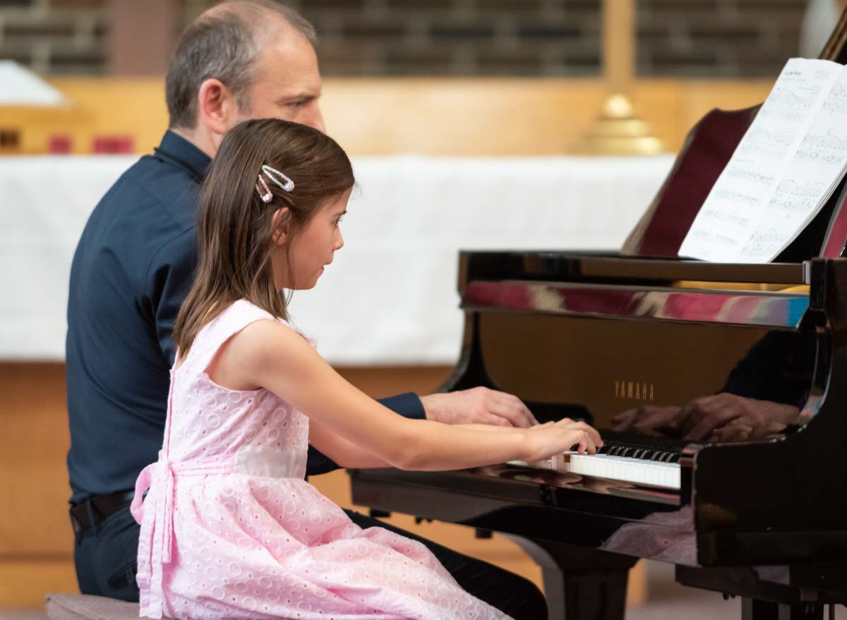 Teacher and young girl student at Artgate Studio playing a piano duet
