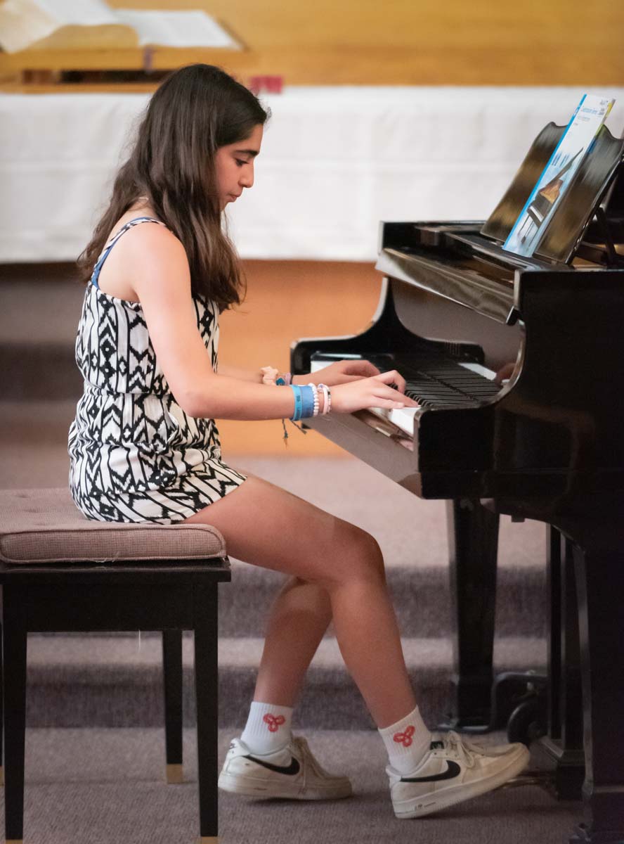 Girl student playing piano in joint recital Music Smart- Artgate